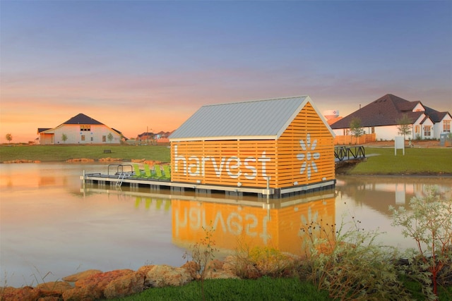 dock area featuring a lawn and a water view