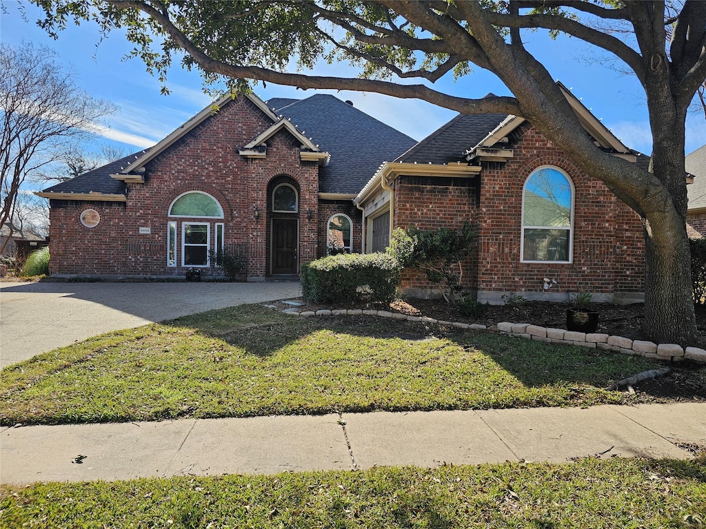 view of front of house featuring a garage and a front lawn