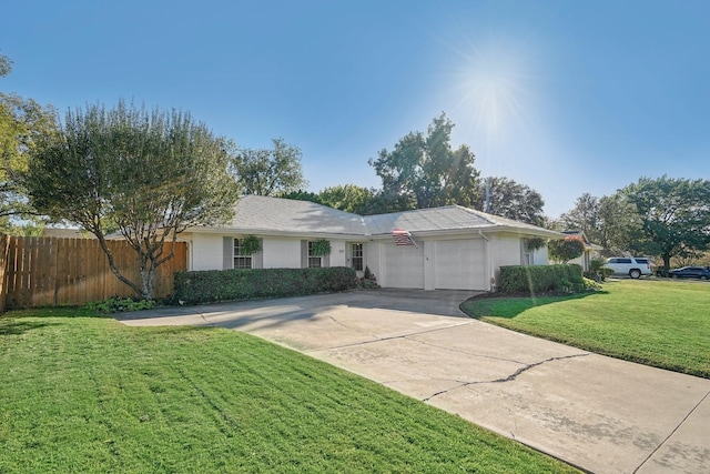 ranch-style house featuring a front lawn and a garage