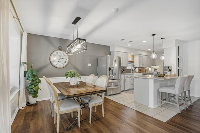 dining area featuring light wood-type flooring