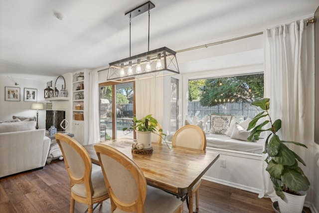 dining room featuring dark wood-type flooring and a chandelier