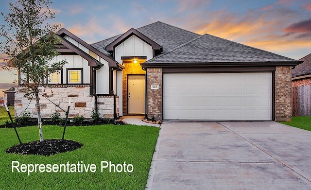 view of front of property featuring a yard and a garage