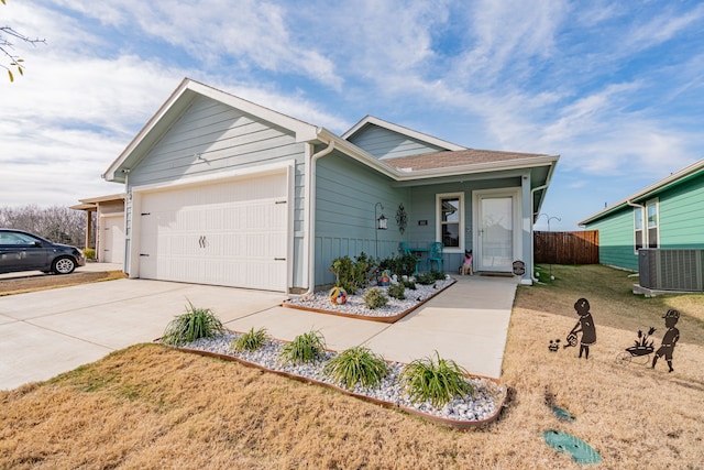 single story home with central AC, a front lawn, and a garage