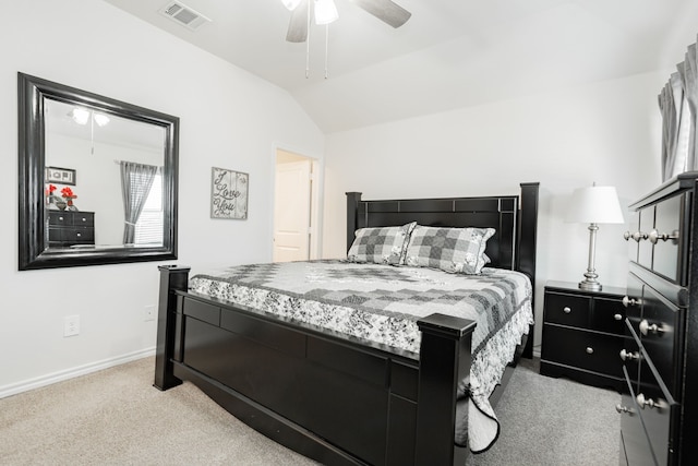 bedroom with ceiling fan, light colored carpet, and lofted ceiling