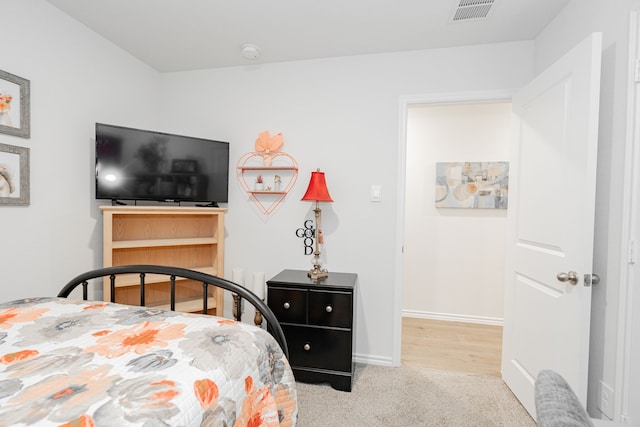 bedroom with light colored carpet