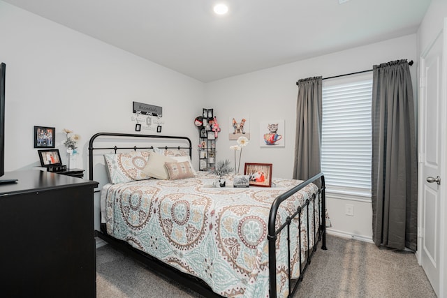 carpeted bedroom featuring multiple windows