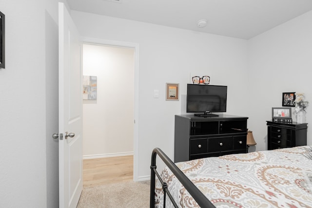 bedroom featuring light colored carpet