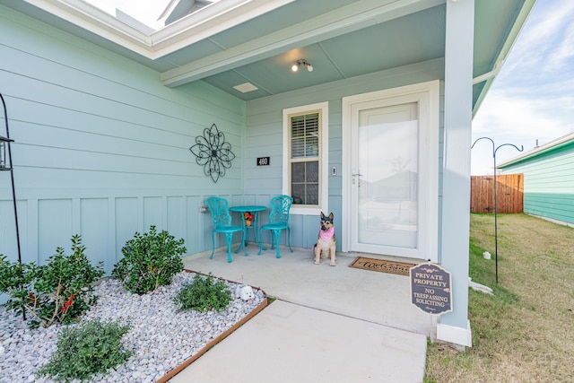 view of exterior entry with a yard