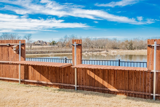 view of yard with a dock and a water view