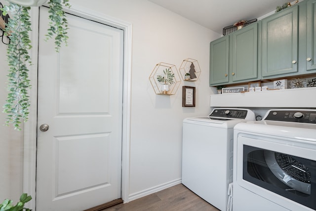 clothes washing area with independent washer and dryer, cabinets, and light hardwood / wood-style floors