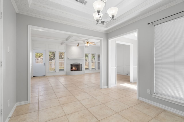 unfurnished living room with ceiling fan with notable chandelier, light tile patterned flooring, a brick fireplace, and plenty of natural light