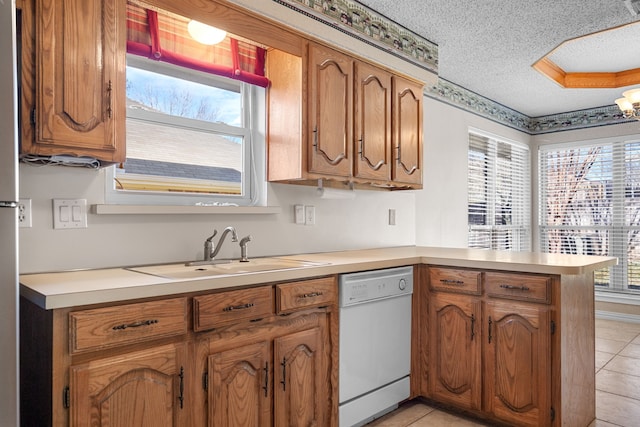 kitchen with kitchen peninsula, a textured ceiling, dishwasher, light tile patterned flooring, and sink