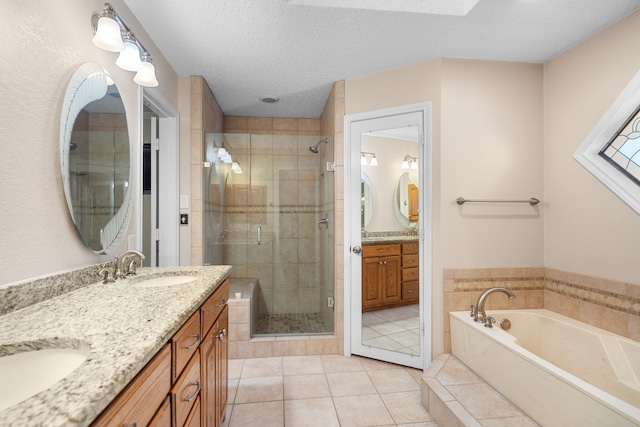 bathroom featuring a textured ceiling, plus walk in shower, tile patterned floors, and vanity