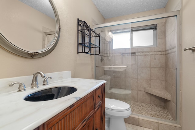 bathroom featuring a textured ceiling, tile patterned flooring, toilet, walk in shower, and vanity