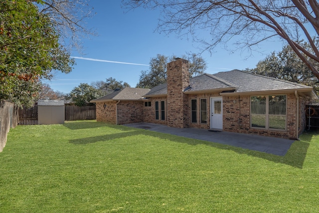 rear view of house with a patio, a yard, and a shed