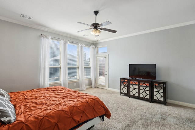 carpeted bedroom featuring ornamental molding and ceiling fan