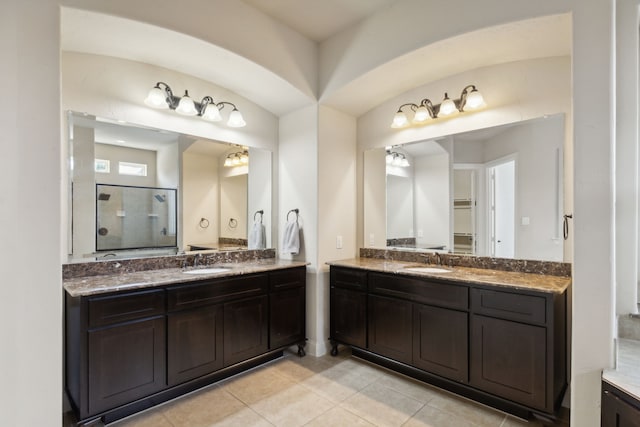 bathroom featuring a shower with door, tile patterned flooring, and vanity