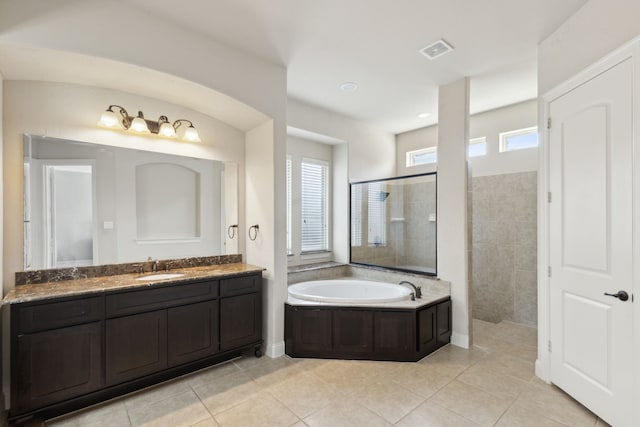 bathroom with independent shower and bath, vanity, and tile patterned floors