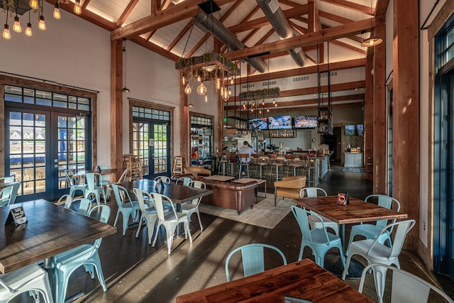 dining room with bar, high vaulted ceiling, french doors, and beamed ceiling