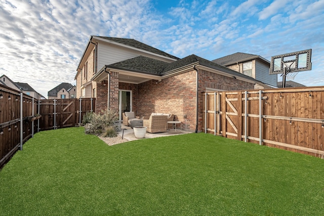 rear view of property featuring a lawn and a patio