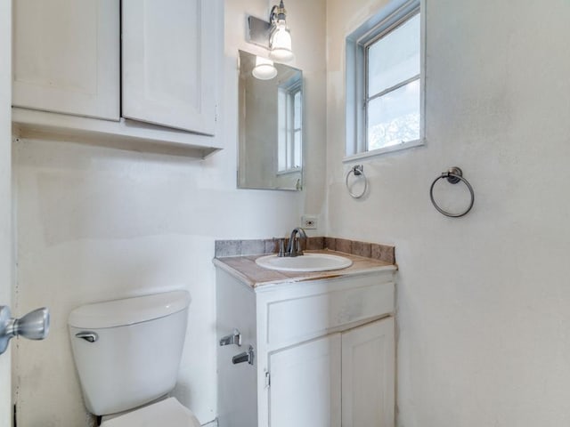 bathroom with toilet and vanity