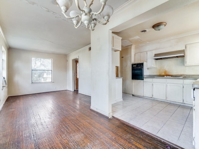 kitchen with light hardwood / wood-style flooring, black appliances, a chandelier, and white cabinetry