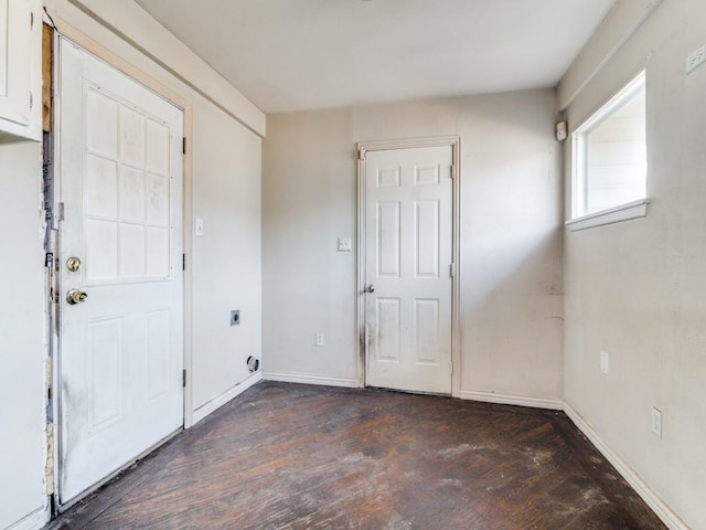 entryway with dark hardwood / wood-style flooring