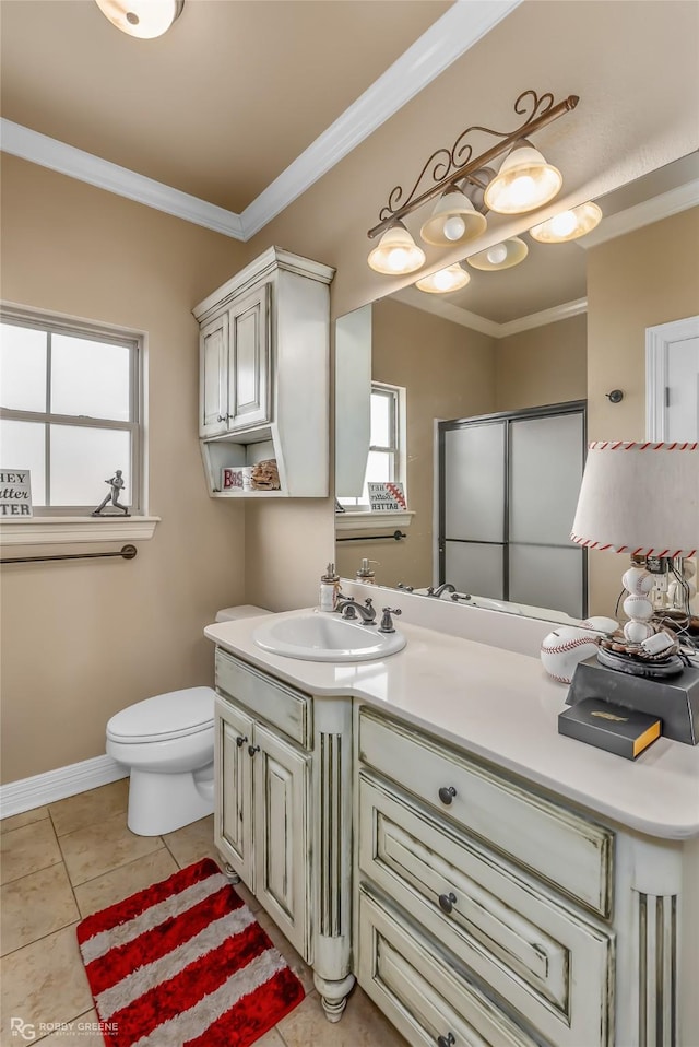 bathroom featuring tile patterned flooring, toilet, crown molding, vanity, and a shower with shower door