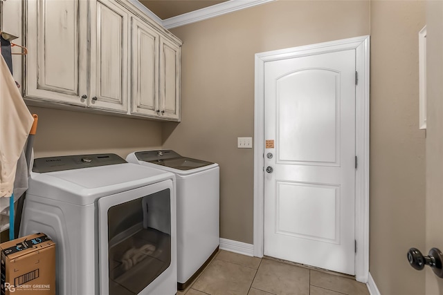 laundry room featuring light tile patterned flooring, cabinets, separate washer and dryer, and crown molding