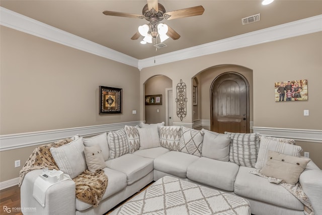 living room with hardwood / wood-style floors, ceiling fan, and crown molding