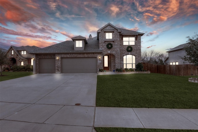 view of front of house featuring a garage and a yard