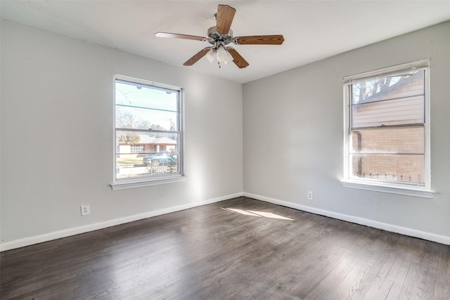 unfurnished room featuring dark wood-type flooring and a healthy amount of sunlight