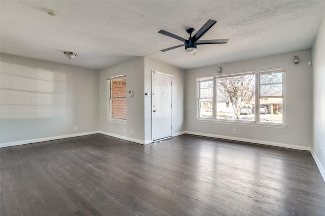 interior space featuring ceiling fan, dark hardwood / wood-style flooring, and a textured ceiling