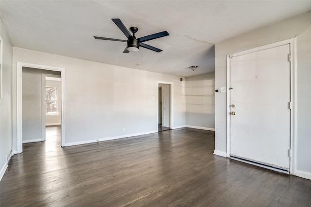 unfurnished room with dark hardwood / wood-style flooring and ceiling fan