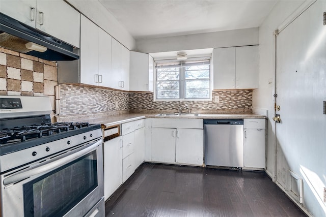 kitchen featuring sink, stainless steel appliances, white cabinetry, and backsplash