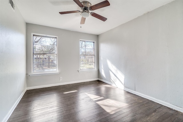 empty room with ceiling fan and dark wood-type flooring