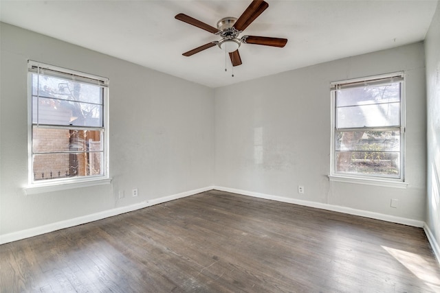 empty room featuring ceiling fan and dark wood-type flooring