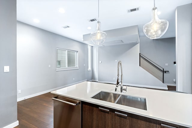 kitchen with stainless steel dishwasher, dark brown cabinetry, hanging light fixtures, and sink