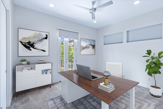 home office with ceiling fan and light carpet