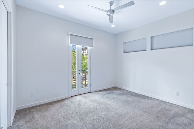 empty room featuring ceiling fan and light carpet