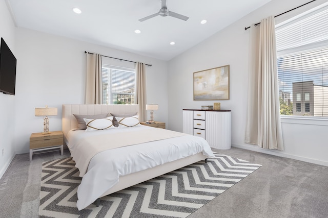 carpeted bedroom featuring lofted ceiling and ceiling fan