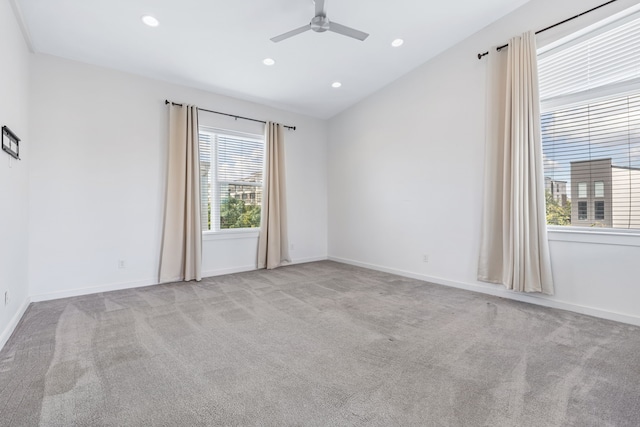 unfurnished room featuring light carpet and ceiling fan