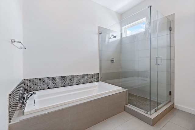 bathroom with separate shower and tub and tile patterned floors