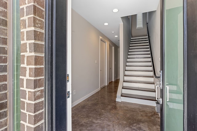 stairway featuring concrete floors