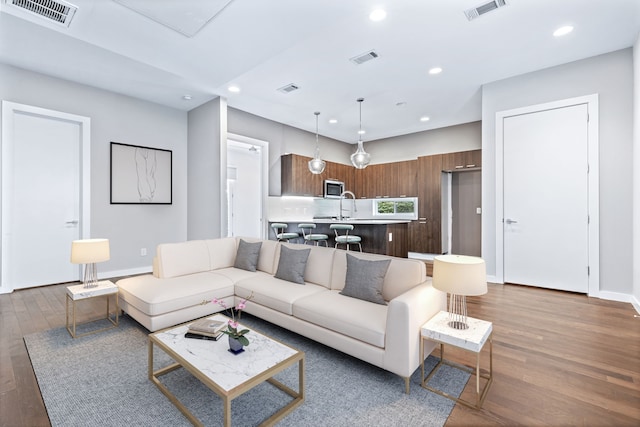 living room with sink and hardwood / wood-style floors