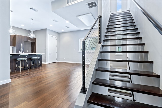 stairs with hardwood / wood-style floors