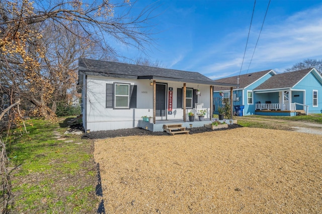 view of front of home with a porch and a front yard