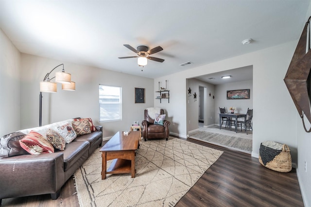 living room featuring ceiling fan and hardwood / wood-style floors