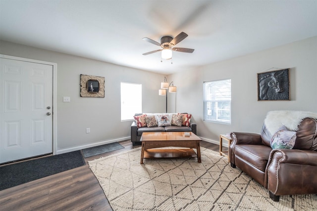 living room featuring ceiling fan, light hardwood / wood-style flooring, and a wealth of natural light