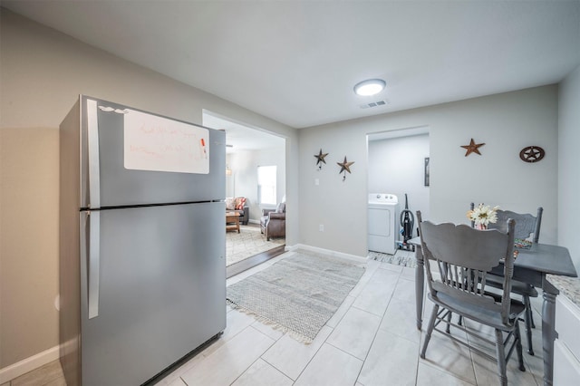 tiled dining area featuring washer / clothes dryer